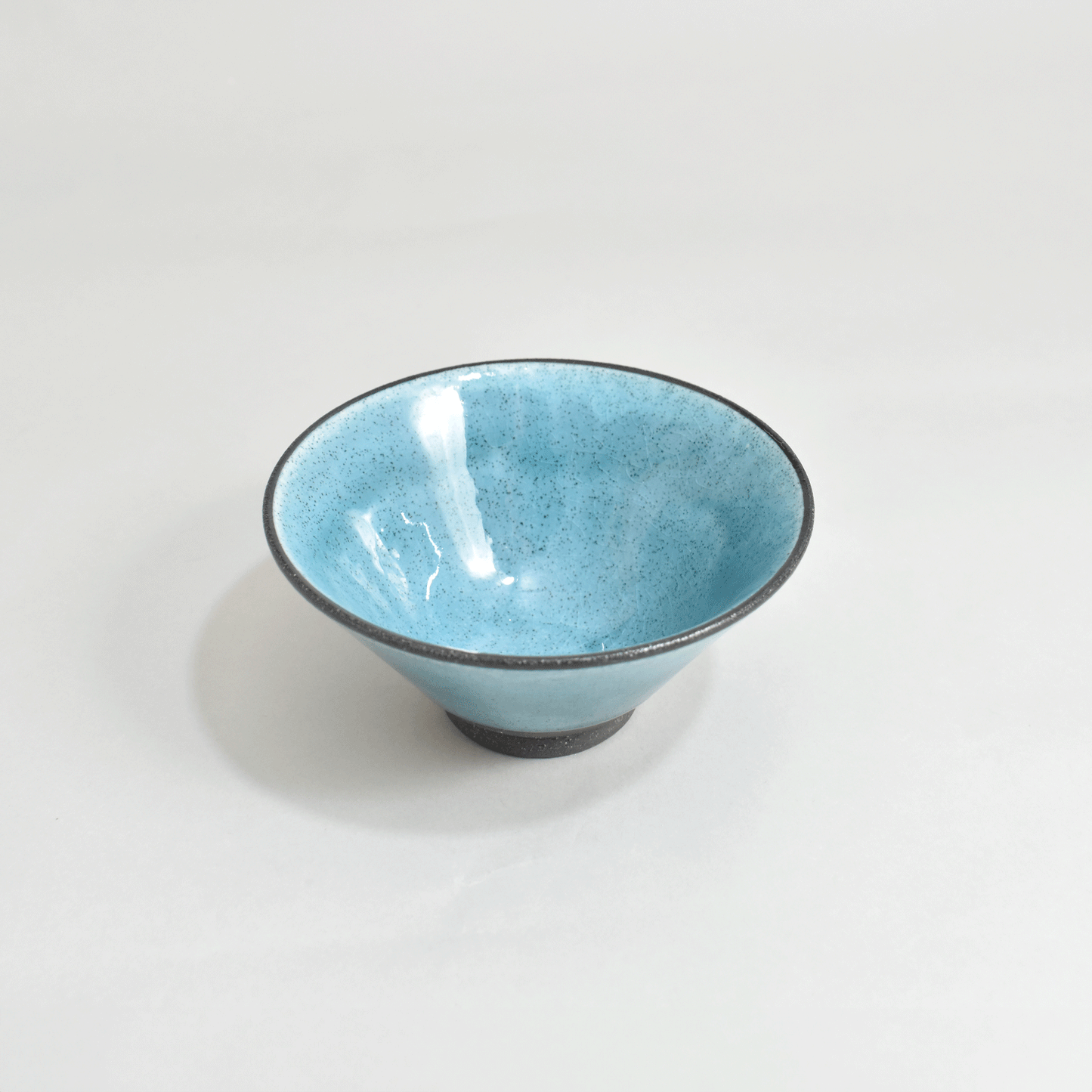 Black clay rice bowl with blue topaz