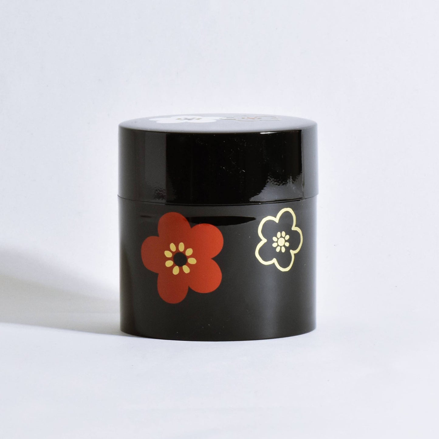Tea canister with black flower pattern and plum blossom