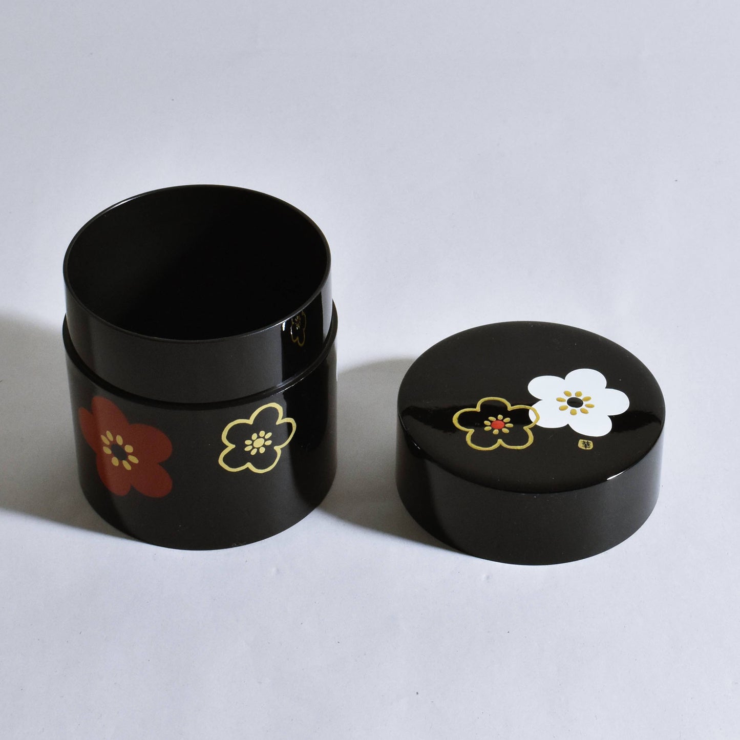 Tea canister with black flower pattern and plum blossom