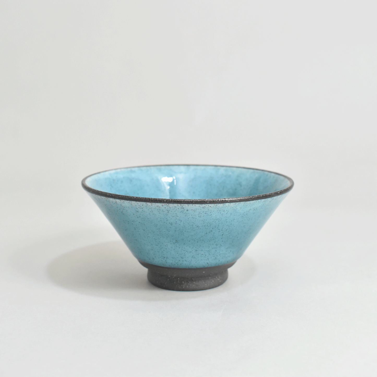 Black clay rice bowl with blue topaz
