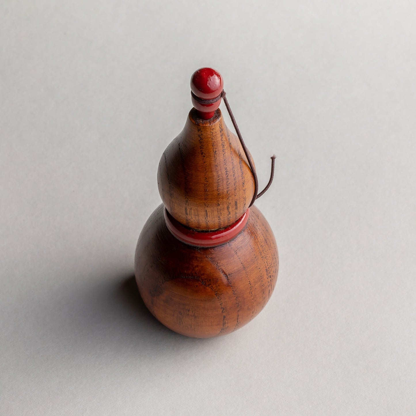 Wooden gourd shichimi container with red handle and string
