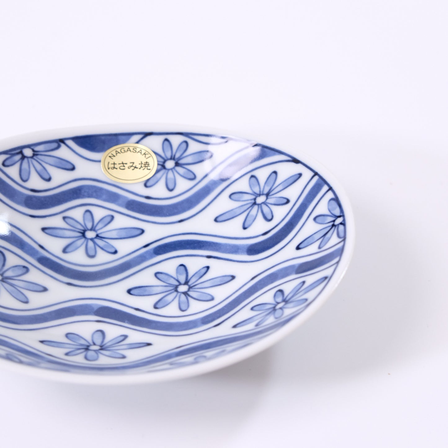Small oval plate with flowing water and floral design