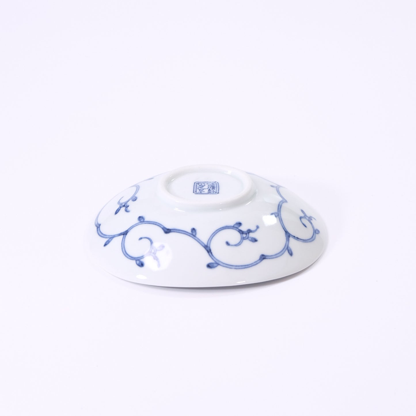 Small oval plate with flowing water and floral design